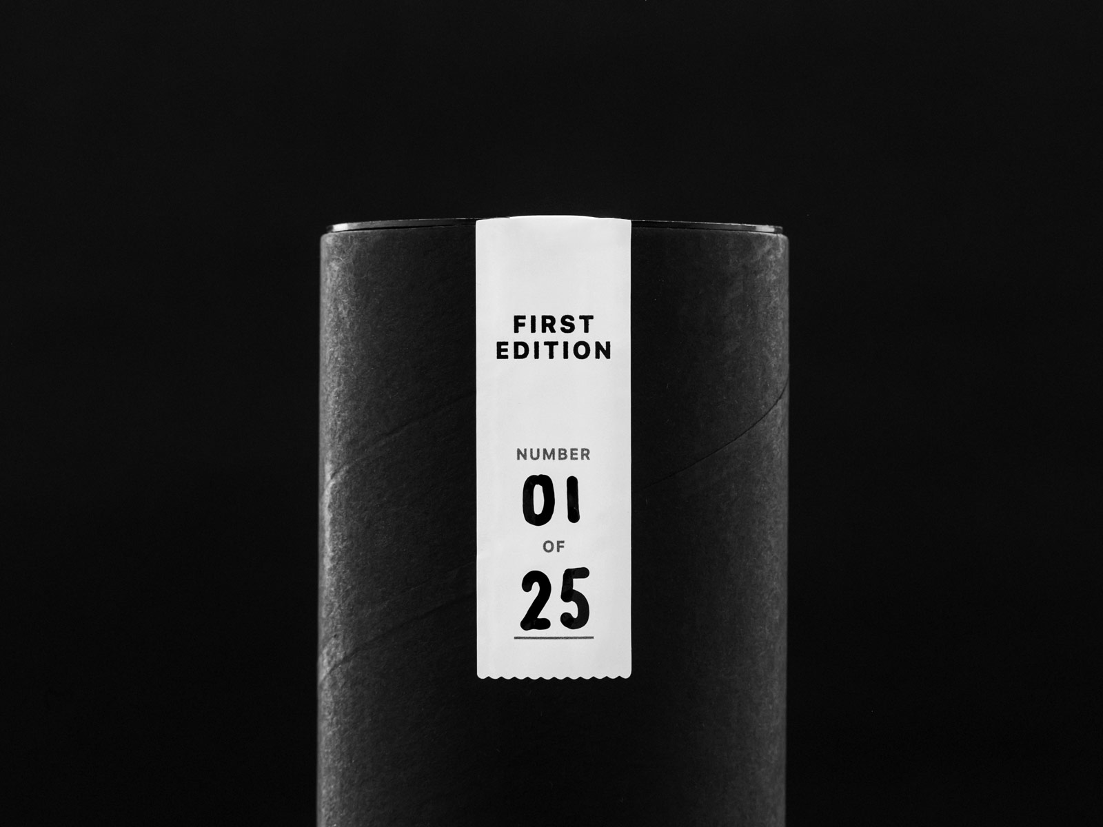Close-up photo of the first edition seal on the black packaging tube